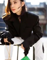 袁姗姗身穿短款外套搭配高腰裤，微微侧身展示出紧致腰部曲线与健康马甲线