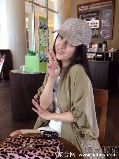 户外阳光下，杨钰莹俏皮地望向远处，笑容灿烂如花，仿佛与周围美景融为一体。