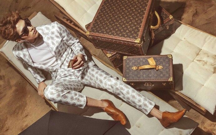 两人海边悠闲漫步，勾勒出奢华惬意的假日图景