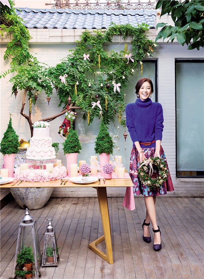 张子萱以手轻托脸颊目光柔和，知性优雅气质在简约背景中凸显