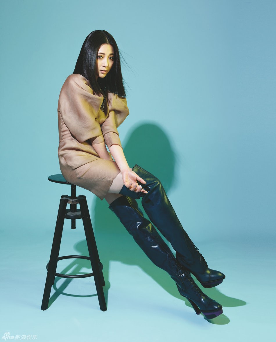 光影交错间殷桃回眸浅笑，黑色装束与精致妆容凸显其经典复古的迷人魅力